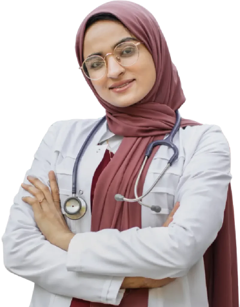 A woman in a hijab stands with her arms crossed