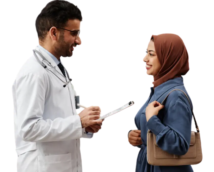 A doctor converses with a woman wearing a hijab, discussing health matters in a professional setting.