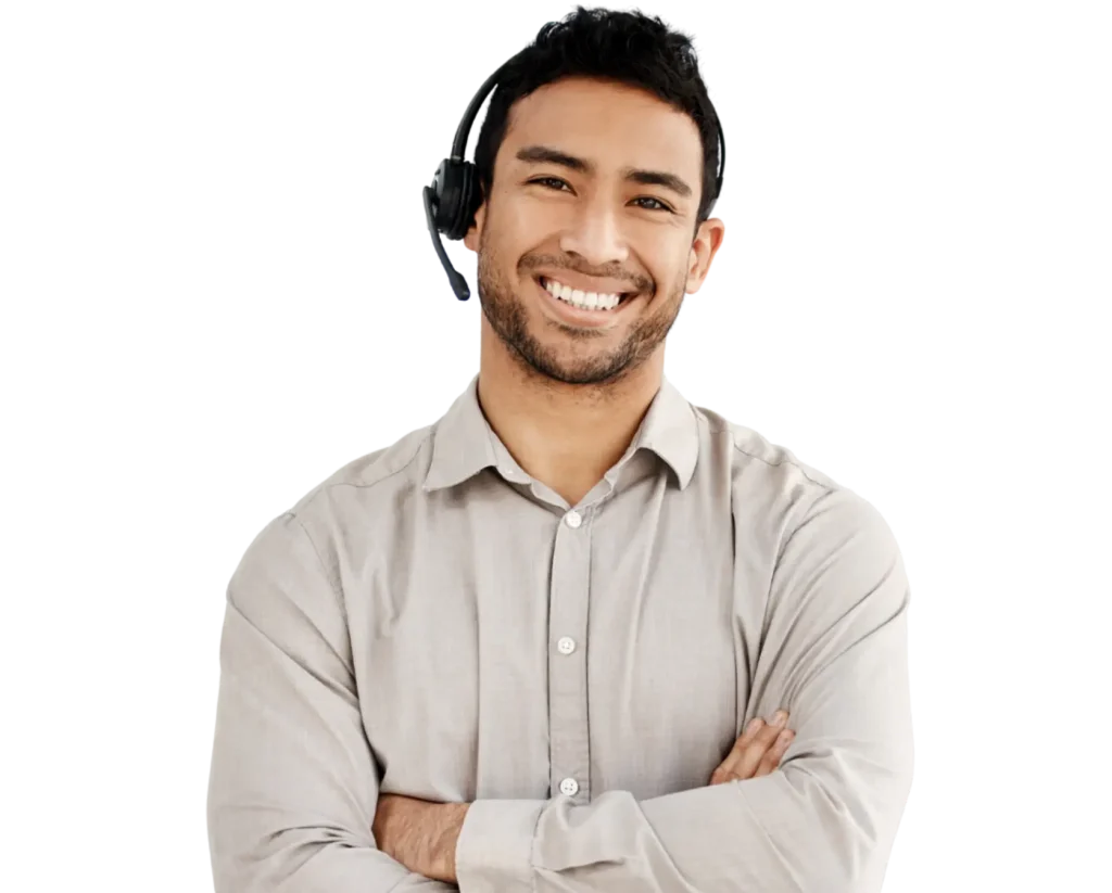 A man with a headset smiles, conveying a friendly and approachable demeanor.
